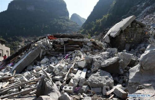 Photo taken on Feb. 8, 2016 shows the site of a landslide at Fude village in Du'an Yao Autonomous County, south China's Guangxi Zhuang Autonomous Region. Six people were killed after a landslide destroyed a two-story building in Du'an early Monday morning. According to local sources, it didn't rain when the accident happened. The cause is being investigated. (Photo: Xinhua/Lu Boan) Photo taken on Feb. 8, 2016 shows the site of a landslide at Fude village in Du'an Yao Autonomous County, south China's Guangxi Zhuang Autonomous Region. Six people were killed after a landslide destroyed a two-story building in Du'an early Monday morning. According to local sources, it didn't rain when the accident happened. The cause is being investigated. (Photo: Xinhua/Lu Boan)