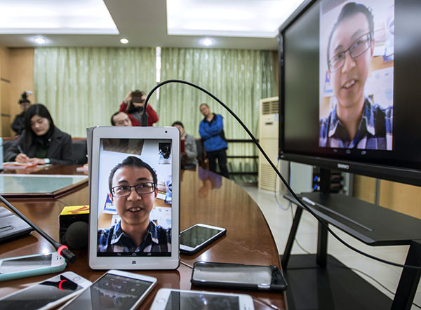 Luo Jialun is interviewed via iPad in Guangzhou, Guangdong province, on Monday. (Photo: China Daily/Liang Jucong)