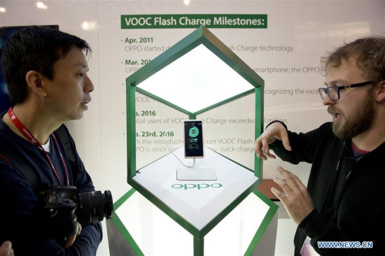 Staff members of Chinese company OPPO display VOOC technology to visistors at the Mobile World Congress in Barcelona, Spain, Feb. 23, 2016. The Mobile World Congress (MWC), the most important mobile communication event in the world, opened its doors in Barcelona Monday. (Photo: Xinhua/Lino De Vallier) Staff members of Chinese company OPPO display VOOC technology to visistors at the Mobile World Congress in Barcelona, Spain, Feb. 23, 2016. The Mobile World Congress (MWC), the most important mobile communication event in the world, opened its doors in Barcelona Monday. (Photo: Xinhua/Lino De Vallier)