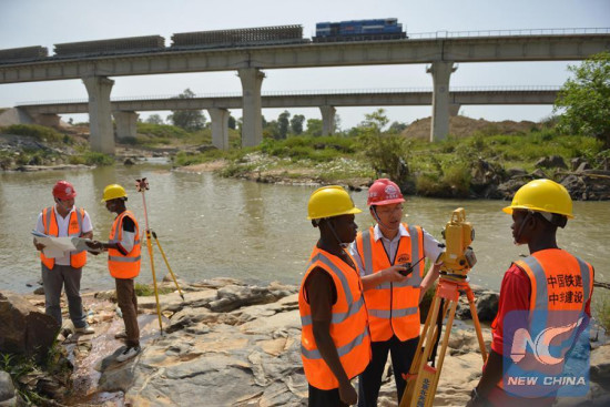 Chinese and local employees work at the construction site of a rail project linking Nigeria's capital city Abuja and its northwestern state of Kaduna, Nov. 25, 2014. The China Railway Construction Corporation carries out the work on the country's first standard gauge railway line. (Xinhua File Photo/Cheng Guangming) Chinese and local employees work at the construction site of a rail project linking Nigeria's capital city Abuja and its northwestern state of Kaduna, Nov. 25, 2014. The China Railway Construction Corporation carries out the work on the country's first standard gauge railway line. (Xinhua File Photo/Cheng Guangming)