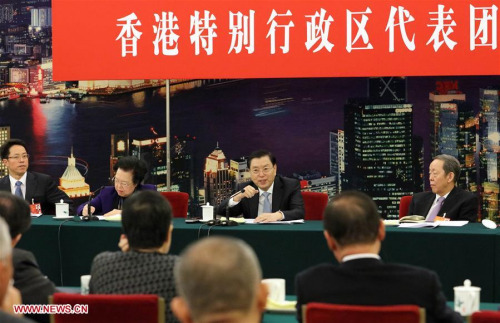 Zhang Dejiang (2nd R, back), chairman of the Standing Committee of China's National People's Congress (NPC), joins a group deliberation of deputies from Hong Kong to the annual session of the NPC in Beijing, capital of China, March 6, 2016. (Photo: Xinhua/Liu Weibing)