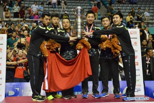 Members and Coach of China's men's table tennis team pose for photo with trophy after winning the final against Japan at the 2016 World Team Championships in Kuala Lumpur, Malaysia, March 6, 2016. China's men's table tennis team won 3-0 to claim their eighth straight men's title at the World Team Table Tennis Championships here on Sunday.(Photo: Xinhua/Chong Voon Chung) Members and Coach of China's men's table tennis team pose for photo with trophy after winning the final against Japan at the 2016 World Team Championships in Kuala Lumpur, Malaysia, March 6, 2016. China's men's table tennis team won 3-0 to claim their eighth straight men's title at the World Team Table Tennis Championships here on Sunday.(Photo: Xinhua/Chong Voon Chung)