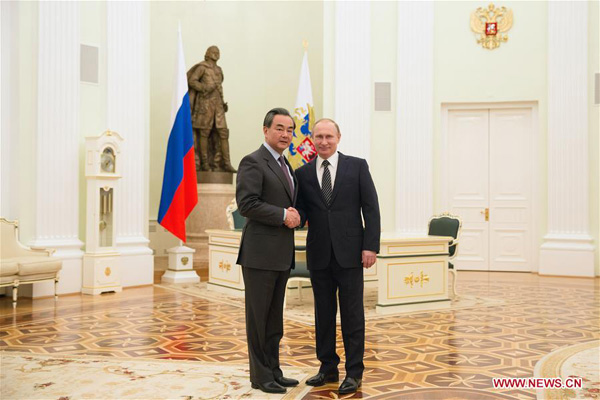Russian President Vladimir Putin (R) shakes hands with visiting Chinese Foreign Minister Wang Yi during their meeting in Moscow, capital of Russia, on March 11, 2016. (Photo/Xinhua) Russian President Vladimir Putin (R) shakes hands with visiting Chinese Foreign Minister Wang Yi during their meeting in Moscow, capital of Russia, on March 11, 2016. (Photo/Xinhua)