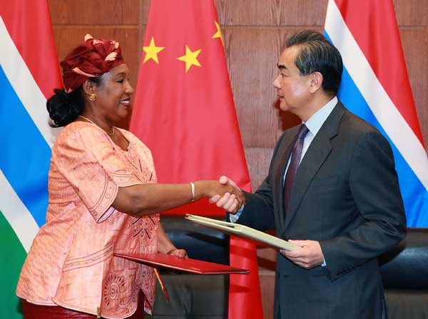 Foreign Minister Wang Yi greets his Gambian counterpart Neneh Macdouall-Gaye at a signing ceremony in Beijing on Thursday. ZOU HONG / CHINA DAILY Foreign Minister Wang Yi greets his Gambian counterpart Neneh Macdouall-Gaye at a signing ceremony in Beijing on Thursday. ZOU HONG / CHINA DAILY