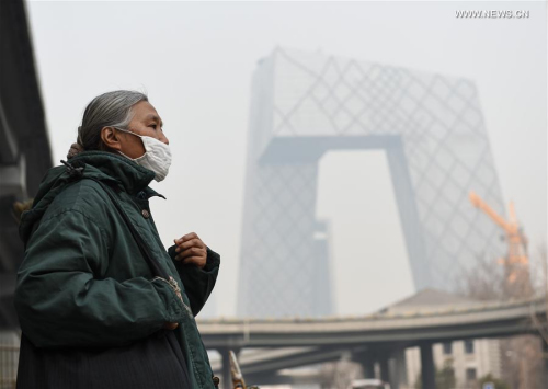 A woman wearing a mask walks past Guomao Bridge in Beijing, capital of China, March 16, 2016. As temperatures rise, dispersal of foul air becomes more difficult. Beijing and its nearby Tianjin and Hebei Province have been smogbound since the start of this week. A yellow alert for air pollution is issued Wednesday afternoon in Beijing. (Photo: Xinhua/Luo Xiaoguang) A woman wearing a mask walks past Guomao Bridge in Beijing, capital of China, March 16, 2016. As temperatures rise, dispersal of foul air becomes more difficult. Beijing and its nearby Tianjin and Hebei Province have been smogbound since the start of this week. A yellow alert for air pollution is issued Wednesday afternoon in Beijing. (Photo: Xinhua/Luo Xiaoguang)