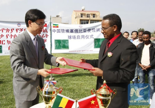 La Yifan, China's Ambassador to Ethiopia, and Dilamo Otore, Vice mayor of Addis Ababa City, exchange documents for handover of a Chinese financed sports field on April 8, 2016 in Ethiopia's Capital Addis Ababa. (Photo: Xinhua/Michael Tewelde) La Yifan, China's Ambassador to Ethiopia, and Dilamo Otore, Vice mayor of Addis Ababa City, exchange documents for handover of a Chinese financed sports field on April 8, 2016 in Ethiopia's Capital Addis Ababa. (Photo: Xinhua/Michael Tewelde)