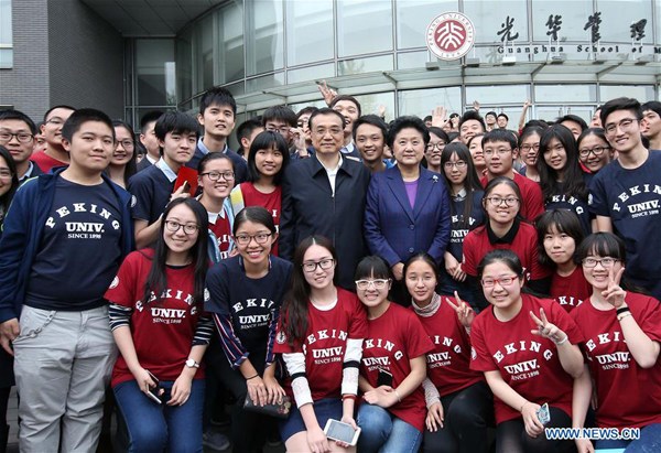 Chinese Premier Li Keqiang poses for a group picture with students of Guanghua School of Management at Peking University in Beijing, capital of China, April 15, 2016. Li on Friday visited Tsinghua and Peking, two prestigious universities in Beijing, to inspect about educational reform development and the implementation of innovation-driven development strategy. (Xinhua/Pang Xinglei) Chinese Premier Li Keqiang poses for a group picture with students of Guanghua School of Management at Peking University in Beijing, capital of China, April 15, 2016. Li on Friday visited Tsinghua and Peking, two prestigious universities in Beijing, to inspect about educational reform development and the implementation of innovation-driven development strategy. (Xinhua/Pang Xinglei)