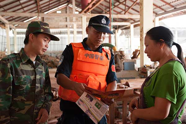 Chinese police provide anti-drug information to local people in Laos during a joint campaign in June.Lyu Shuai / Xinhua Chinese police provide anti-drug information to local people in Laos during a joint campaign in June.Lyu Shuai / Xinhua