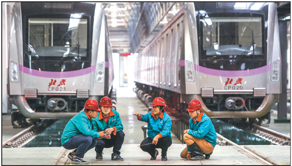 Project manager Cui Hongjun (second from right) and three members of her maintenance team for Beijing Metro Line 13 prepare to examine subway trains at a workshop in Beijing's Changping district. Shen Bohan / Xinhua Project manager Cui Hongjun (second from right) and three members of her maintenance team for Beijing Metro Line 13 prepare to examine subway trains at a workshop in Beijing's Changping district. Shen Bohan / Xinhua