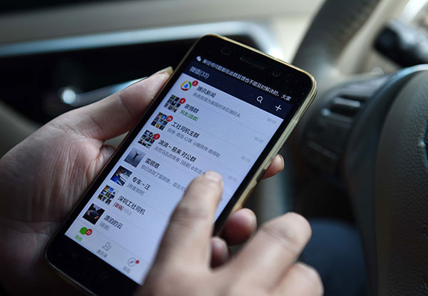 Xia Zhengwu checks messages from customers on his smartphone.Zhang Wei/For China Daily Xia Zhengwu checks messages from customers on his smartphone.Zhang Wei/For China Daily