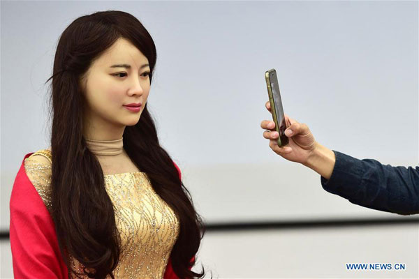 An interactive robot named Jiajia, who looks very much like a real woman, is unveiled by the University of Science and Techonology of China in Hefei, capital of East China's Anhui province, April 15, 2016. (Photo/Xinhua)