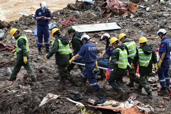 Rescuers carry a body of victim at the landslide site in Taining County, southeast China's Fujian Province, May 9, 2016. Thirty-one bodies have been found and 7 people remain missing after a landslide hit Taining County in Fujian. (Photo: Xinhua/Zhang Guojun) Rescuers carry a body of victim at the landslide site in Taining County, southeast China's Fujian Province, May 9, 2016. Thirty-one bodies have been found and 7 people remain missing after a landslide hit Taining County in Fujian. (Photo: Xinhua/Zhang Guojun)