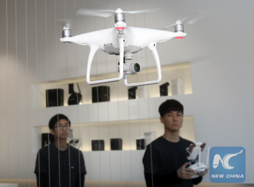 A staff member of major Chinese consumer-drone maker DJI shows Phantom 4, the latest consumer quadcopter camera (or drone) introduced by DJI last week, at DJI's flagship store in Seoul, capital of South Korea, on March 11, 2016. (Photo: Xinhua/Yao Qilin) A staff member of major Chinese consumer-drone maker DJI shows Phantom 4, the latest consumer quadcopter camera (or drone) introduced by DJI last week, at DJI's flagship store in Seoul, capital of South Korea, on March 11, 2016. (Photo: Xinhua/Yao Qilin)