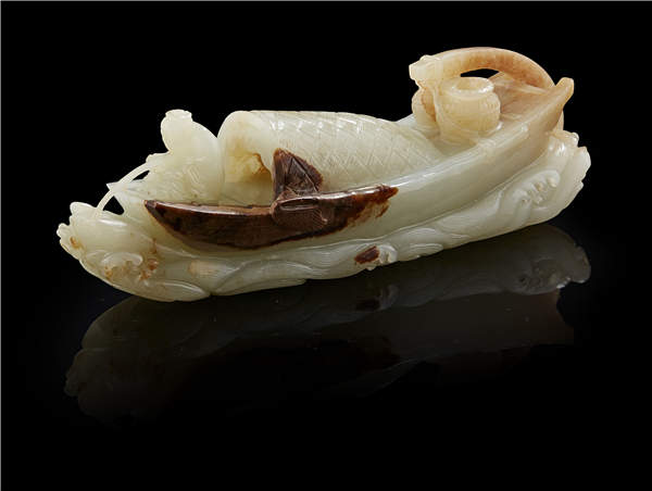 A Qing Dynasty celadon jade carving of a boat. A Qing Dynasty celadon jade carving of a boat.