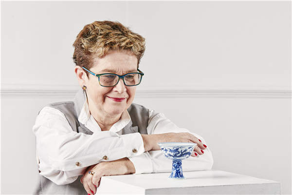Rosy Crehan, deputy vice-chancellor of Staffordshire University, with the stem cup that will be auctioned to finance a new museum. Photos provided to China Daily Rosy Crehan, deputy vice-chancellor of Staffordshire University, with the stem cup that will be auctioned to finance a new museum. Photos provided to China Daily