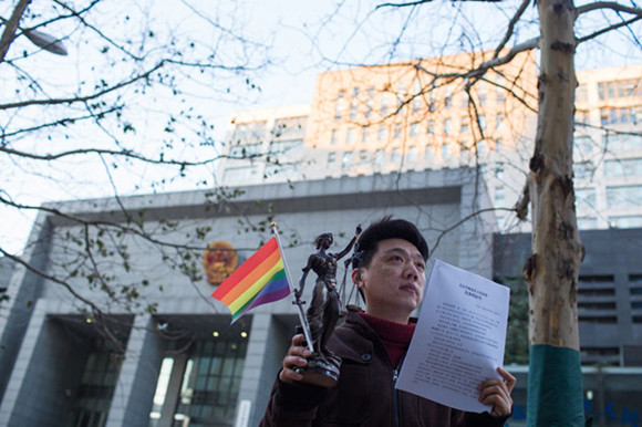 Xiao Zhen stands holding the judgment that rules against a psychological counseling center offering gay conversion therapy in Beijing. Photo: Courtesy of Xiao Zhen Xiao Zhen stands holding the judgment that rules against a psychological counseling center offering gay conversion therapy in Beijing. Photo: Courtesy of Xiao Zhen