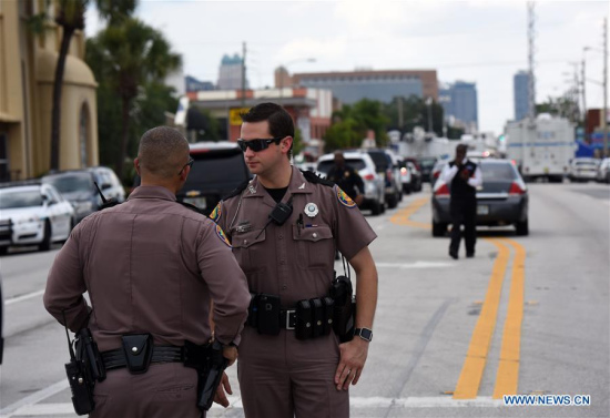 Highway-patrol troopers stand guard near the mass shooting scene in Orlando, the United States, June 12, 2016. At least fifty people were killed and 53 others wounded early Sunday in a shooting spree at a gay nightclub in Orlando, Florida. (Xinhua/Yin Bogu)