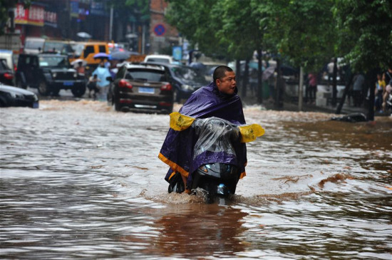 A man rides on a waterlogged road after a heavy rainfall in Zhuzhou City, central China's Hunan Province, June 15, 2016. (Photo: Xinhua/Long Hongtao) A man rides on a waterlogged road after a heavy rainfall in Zhuzhou City, central China's Hunan Province, June 15, 2016. (Photo: Xinhua/Long Hongtao)