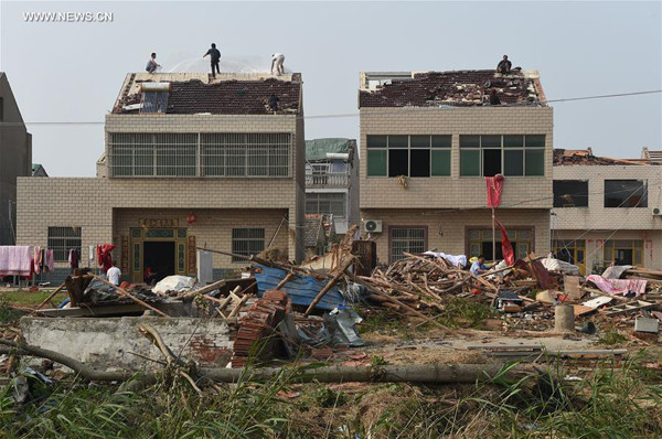 Villagers repair their damaged roof at Jiqiao Village under Shuoji Township in Funing County of Yancheng City, east China's Jiangsu Province, June 25, 2016. Rain, hail and a tornado battered parts of Yancheng City on Thursday afternoon, destroying buildings, trees, vehicles and electricity poles. At least 98 people have died and 846 were injured. (Xinhua/Han Yuqing) Villagers repair their damaged roof at Jiqiao Village under Shuoji Township in Funing County of Yancheng City, east China's Jiangsu Province, June 25, 2016. Rain, hail and a tornado battered parts of Yancheng City on Thursday afternoon, destroying buildings, trees, vehicles and electricity poles. At least 98 people have died and 846 were injured. (Xinhua/Han Yuqing)
