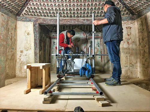 Staff scan a mural in the Mogao Caves in Gansu Province on May 31. (Photo: Li Jingjing/GT) Staff scan a mural in the Mogao Caves in Gansu Province on May 31. (Photo: Li Jingjing/GT)