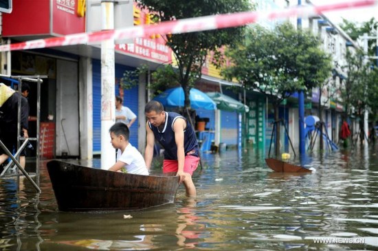 Photo taken on July 3, 2016 shows the scene of a waterlogged street in Xuancheng City, east China's Anhui Province. Many regions in Anhui were flooded due to heavy rainfall in recent days. (Xinhua/Meng Dingbo) Photo taken on July 3, 2016 shows the scene of a waterlogged street in Xuancheng City, east China's Anhui Province. Many regions in Anhui were flooded due to heavy rainfall in recent days. (Xinhua/Meng Dingbo)