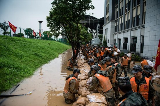 Rescuers reinforce a temporary dyke in Shuren Middle School in Nanjing, capital of east China's Jiangsu Province, July 4, 2016. A section of the embankment of Yangtze River near the school was found continuing leakage Monday morning, and a temporary dyke was built to stop flood water. (Xinhua/Li Xiang) Rescuers reinforce a temporary dyke in Shuren Middle School in Nanjing, capital of east China's Jiangsu Province, July 4, 2016. A section of the embankment of Yangtze River near the school was found continuing leakage Monday morning, and a temporary dyke was built to stop flood water. (Xinhua/Li Xiang)
