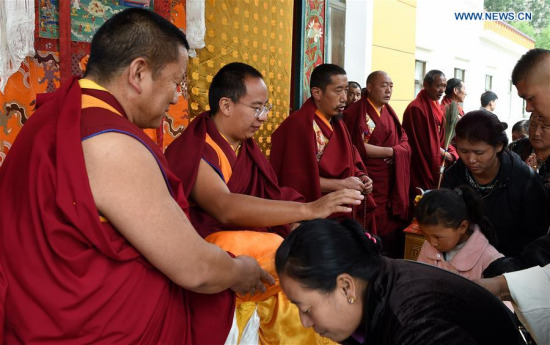 The 11th Panchen Lama (2nd L), Bainqen Erdini Qoigyijabu, touches the heads of Buddhism followers to give blessings during the Saga Dawa Festival in Lhasa, capital of southwest China's Tibet Autonomous Region, May 21, 2016. Buddha's birthday, April 15 according to Tibetan calendar, falls on May 21 this year and it's an important day of the festival. (Xinhua file photo/Chogo) The 11th Panchen Lama (2nd L), Bainqen Erdini Qoigyijabu, touches the heads of Buddhism followers to give blessings during the Saga Dawa Festival in Lhasa, capital of southwest China's Tibet Autonomous Region, May 21, 2016. Buddha's birthday, April 15 according to Tibetan calendar, falls on May 21 this year and it's an important day of the festival. (Xinhua file photo/Chogo)