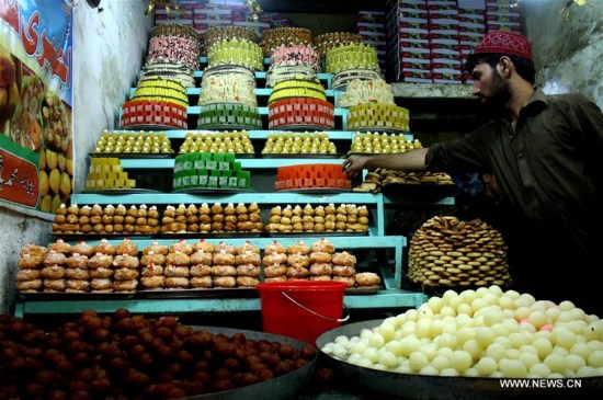 A man arranges traditional sweets at a bakery ahead of Eid al-Fitr festival in Pakistan's northwest Peshawar on July 5, 2016. Eid al-Fitr, a major Muslim holiday, marks the end of the holy month of Ramadan. (Xinhua/Ahmad Sidique) A man arranges traditional sweets at a bakery ahead of Eid al-Fitr festival in Pakistan's northwest Peshawar on July 5, 2016. Eid al-Fitr, a major Muslim holiday, marks the end of the holy month of Ramadan. (Xinhua/Ahmad Sidique)