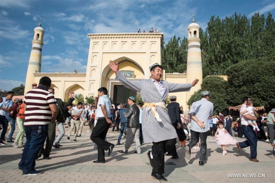Muslims dance in front of the Id Kah Mosque in Kashgar, northwest China's Xinjiang Uygur Autonomous Region, July 6, 2016. Muslims on Wednesday across China celebrated the Eid al-Fitr, which marks the end of the Muslim holy month of Ramadan. (Xinhua/Bu Duomen) Muslims dance in front of the Id Kah Mosque in Kashgar, northwest China's Xinjiang Uygur Autonomous Region, July 6, 2016. Muslims on Wednesday across China celebrated the Eid al-Fitr, which marks the end of the Muslim holy month of Ramadan. (Xinhua/Bu Duomen)
