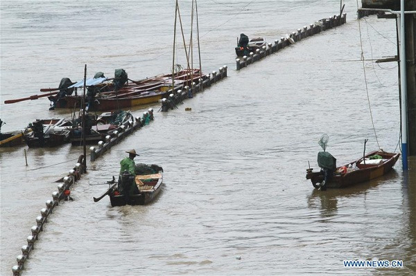 A fisherman takes his boat to safety in Shunchang County, Nanping City of southeast China's Fujian Province, May 20, 2016. Water level reached beyond the warning line in some areas of Min River branches as heavy rain hit Fujian here on Friday. (Xinhua file photo/Chen Baicai) A fisherman takes his boat to safety in Shunchang County, Nanping City of southeast China's Fujian Province, May 20, 2016. Water level reached beyond the warning line in some areas of Min River branches as heavy rain hit Fujian here on Friday. (Xinhua file photo/Chen Baicai)
