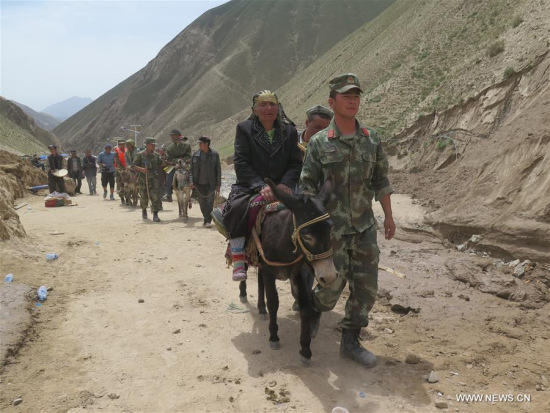 Villagers of Kokyar Township head to a relocation place in Yecheng County of Kashgar Prefecture, northwest China's Xinjiang Uygur Autonomous Region, July 9, 2016. A landslide here has claimed 35 lives and 198 villagers have been transferred to safe places. (Xinhua/Ma Kai) Villagers of Kokyar Township head to a relocation place in Yecheng County of Kashgar Prefecture, northwest China's Xinjiang Uygur Autonomous Region, July 9, 2016. A landslide here has claimed 35 lives and 198 villagers have been transferred to safe places. (Xinhua/Ma Kai)