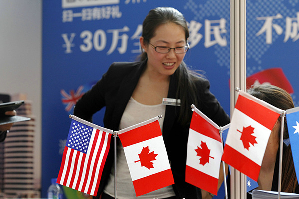 A mother of a student reviews information at a recent promotional event for US and Canadian properties in Beijing. (Photo/China Daily) A mother of a student reviews information at a recent promotional event for US and Canadian properties in Beijing. (Photo/China Daily)