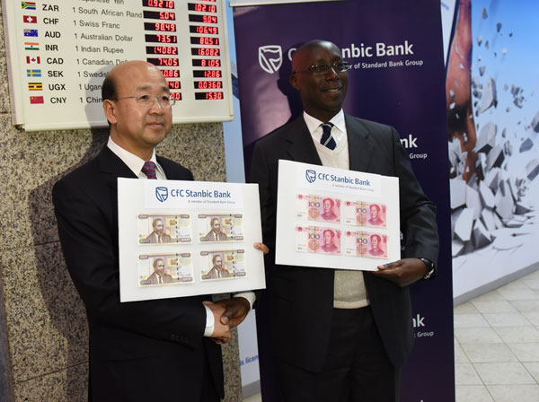 Ambassador Liu and Mr. Odera pose for a photo after completing the first two transactions.Photo/Li Baishun Ambassador Liu and Mr. Odera pose for a photo after completing the first two transactions.Photo/Li Baishun
