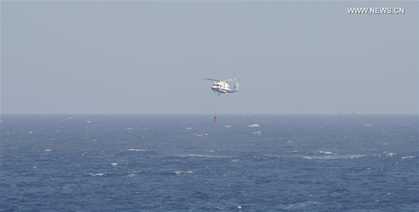 A helicopter is sent to rescue a crew member during an emergency drill at seas near Sansha in south China's Hainan Province, July 14, 2016. An emergency drill involving 13 ships and a helicopter was held Thursday morning at seas near Sansha in Hainan, the city's marine bureau said. (Xinhua/Liu Deng) A helicopter is sent to rescue a crew member during an emergency drill at seas near Sansha in south China's Hainan Province, July 14, 2016. An emergency drill involving 13 ships and a helicopter was held Thursday morning at seas near Sansha in Hainan, the city's marine bureau said. (Xinhua/Liu Deng)
