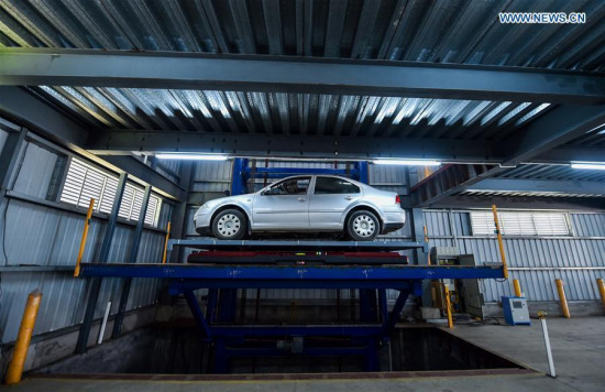 An AGV parking robot has parked a car onto an elevator at a robot company in Shenzhen, south China's Guangdong Province, July 15, 2016. (Xinhua/Mao Siqian) An AGV parking robot has parked a car onto an elevator at a robot company in Shenzhen, south China's Guangdong Province, July 15, 2016. (Xinhua/Mao Siqian)