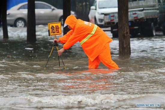 A rescuer places a warning plate on a flooded road in Shijiazhuang, capital of North China's Hebei province, July 19, 2016. Heavy rain afflicted some regions of North China on July 19, causing serious waterlogging in many cities. (Photo/Xinhua) A rescuer places a warning plate on a flooded road in Shijiazhuang, capital of North China's Hebei province, July 19, 2016. Heavy rain afflicted some regions of North China on July 19, causing serious waterlogging in many cities. (Photo/Xinhua)