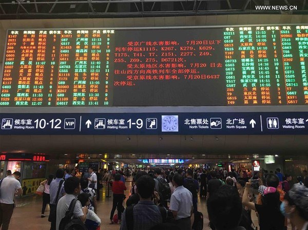 passengers checking train information at the Beijing West Railway Station in Beijing, capital of China on July 20, 2016.The continuous rain led to delay or suspension of several trains to and from Beijing. (Photo:Xinhua/Wang Jianhua) passengers checking train information at the Beijing West Railway Station in Beijing, capital of China on July 20, 2016.The continuous rain led to delay or suspension of several trains to and from Beijing. (Photo:Xinhua/Wang Jianhua)