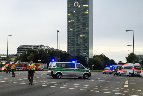 Photo taken by a mobile device shows police standing guard near the site of the shootout in Munich, Germany, on July 22, 2016. At least six people were killed in a shootout in the German city of Munich on Friday evening, German local media Focus Online reported. (Xinhua/Zhu Sheng) Photo taken by a mobile device shows police standing guard near the site of the shootout in Munich, Germany, on July 22, 2016. At least six people were killed in a shootout in the German city of Munich on Friday evening, German local media Focus Online reported. (Xinhua/Zhu Sheng)