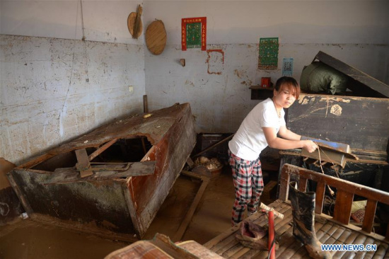 A villager clears the debris at her home in Nanshitun village of Xingtai City, north China's Hebei Province, July 24, 2016. (Xinhua/Wang Xiao) A villager clears the debris at her home in Nanshitun village of Xingtai City, north China's Hebei Province, July 24, 2016. (Xinhua/Wang Xiao)