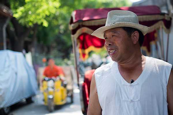 As a rickshaw driver in the hutong, Xin Yingwu witnessed the rise of modern commercialization first-hand.(Photo by Kyle Hodges/chinadaily.com.cn) As a rickshaw driver in the hutong, Xin Yingwu witnessed the rise of modern commercialization first-hand.(Photo by Kyle Hodges/chinadaily.com.cn)