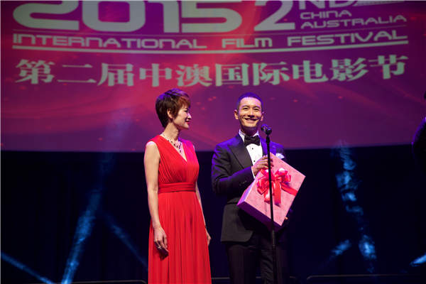 Tina Liu, executive president of the China Australia Film Festival, presents a wedding gift to Chinese actor Huang Xiaoming at last year's festival. Provided To China Daily Tina Liu, executive president of the China Australia Film Festival, presents a wedding gift to Chinese actor Huang Xiaoming at last year's festival. Provided To China Daily
