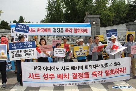 People attend a rally to protest against deploying the U.S. missile defense system, called Terminal High Altitude Area Defense (THAAD), in front of the defense ministry in Seoul,South Korea, July 13, 2016. South Korea's defense ministry on Wednesday announced an agreement with theUnited Statesto deploy the U.S. missile defense system, called Terminal High Altitude Area Defense (THAAD), to its southeastern region despite continued opposition from neighboring countries. (Xinhua/Wang Jiahui) People attend a rally to protest against deploying the U.S. missile defense system, called Terminal High Altitude Area Defense (THAAD), in front of the defense ministry in Seoul,South Korea, July 13, 2016. South Korea's defense ministry on Wednesday announced an agreement with theUnited Statesto deploy the U.S. missile defense system, called Terminal High Altitude Area Defense (THAAD), to its southeastern region despite continued opposition from neighboring countries. (Xinhua/Wang Jiahui)
