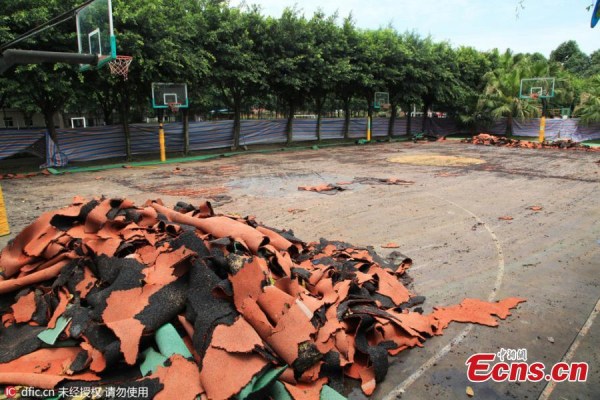 A bulldozer demolishes synthetic running tracks and sports fields at a private elementary school in Chengdu City, the capital of Southwest China's Sichuan Province, June 15, 2016. A bulldozer demolishes synthetic running tracks and sports fields at a private elementary school in Chengdu City, the capital of Southwest China's Sichuan Province, June 15, 2016.