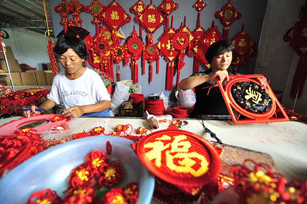Two women make Chinese knots at the factory owned by entrepreneur Wang Chao at Honghua town in Linyi. (Photo by Lu Peng/Xinhua) Two women make Chinese knots at the factory owned by entrepreneur Wang Chao at Honghua town in Linyi. (Photo by Lu Peng/Xinhua)