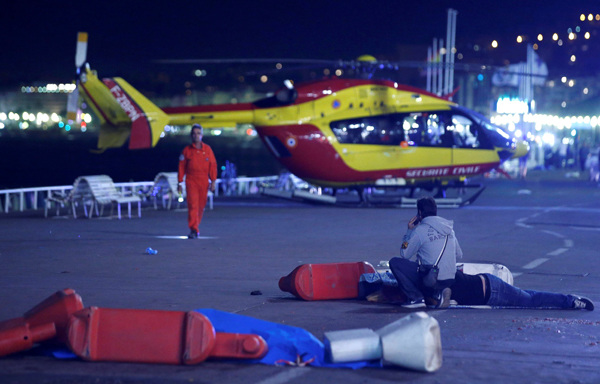 An injured individual is seen on the ground after at least 30 people were killed in Nice, France, when a truck ran into a crowd celebrating the Bastille Day national holiday July 14, 2016. An injured individual is seen on the ground after at least 30 people were killed in Nice, France, when a truck ran into a crowd celebrating the Bastille Day national holiday July 14, 2016.