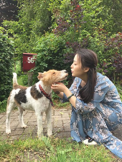 Yu Zhu with her pet dog. CHINA DAILY Yu Zhu with her pet dog. CHINA DAILY