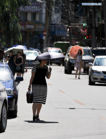 A woman holds an umbrella to shield herself from the sun in Hohhot, capital of north China's Inner Mongolia Autonomous Region, Aug. 3, 2016. (Xinhua/Lian Zhen) A woman holds an umbrella to shield herself from the sun in Hohhot, capital of north China's Inner Mongolia Autonomous Region, Aug. 3, 2016. (Xinhua/Lian Zhen)