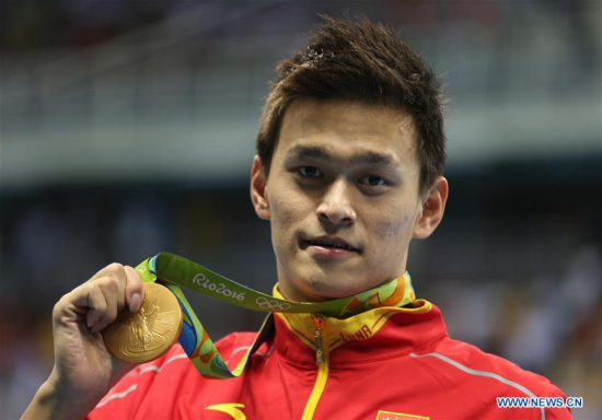 Sun Yang of China shows his medal during the awarding ceremony of men's 200m freestyle swimming final at the 2016 Rio Olympic Games in Rio de Janeiro, Brazil, on Aug. 8, 2016. Sun Yang won the gold medal with 1 minute 44.65 seconds.(Xinhua/Fei Maohua) Sun Yang of China shows his medal during the awarding ceremony of men's 200m freestyle swimming final at the 2016 Rio Olympic Games in Rio de Janeiro, Brazil, on Aug. 8, 2016. Sun Yang won the gold medal with 1 minute 44.65 seconds.(Xinhua/Fei Maohua)