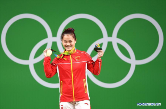 Deng Wei of China celebrates at the awarding ceremony of the women's 63KG weightlifting group A final at the 2016 Rio Olympic Games in Rio de Janeiro, Brazil, on Aug. 9, 2016. Deng Wei won gold medal with clean and jerk, total world records. (Xinhua/Cheng Min) Deng Wei of China celebrates at the awarding ceremony of the women's 63KG weightlifting group A final at the 2016 Rio Olympic Games in Rio de Janeiro, Brazil, on Aug. 9, 2016. Deng Wei won gold medal with clean and jerk, total world records. (Xinhua/Cheng Min)