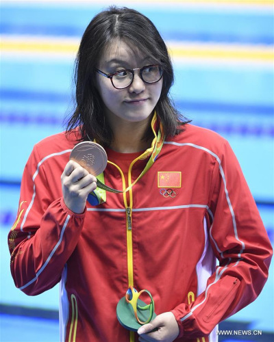 China's Fu Yuanhui attends the awarding ceremony of women's 100m backstroke swimming final at the 2016 Rio Olympic Games in Rio de Janeiro, Brazil, on Aug. 8, 2016. Fu Yuanhui won the bronze medal with 58.76 seconds. (Xinhua/Wang Peng) China's Fu Yuanhui attends the awarding ceremony of women's 100m backstroke swimming final at the 2016 Rio Olympic Games in Rio de Janeiro, Brazil, on Aug. 8, 2016. Fu Yuanhui won the bronze medal with 58.76 seconds. (Xinhua/Wang Peng)